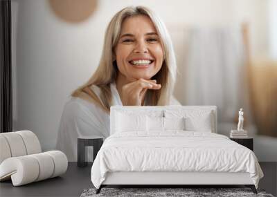 Happy blonde woman posing at white bathroom at home Wall mural