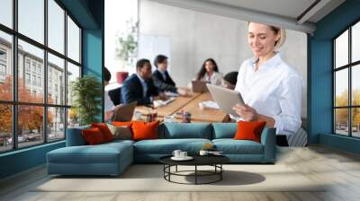 Happy Businesswoman Using Digital Tablet Computer Standing In Modern Office Wall mural