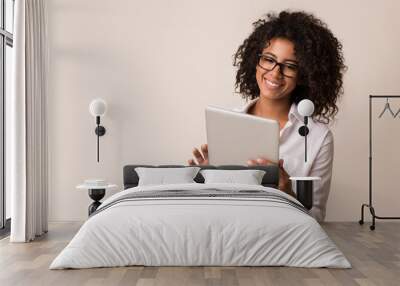 happy businesswoman using tablet over light background Wall mural