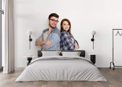 Happy couple at white background standing back to back Wall mural