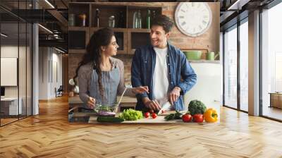 Happy couple cooking healthy dinner together Wall mural