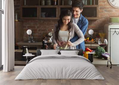 Happy couple cooking healthy food together Wall mural