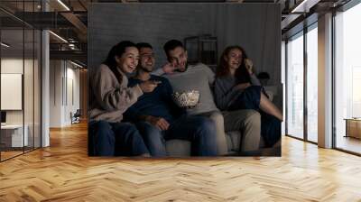 Happy friends watching comedy film at home Wall mural