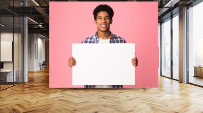 Happy guy showing blank placard with copy space for your text Wall mural