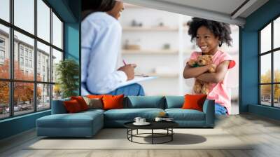 Happy little african american girl at therapy session with psychologist Wall mural