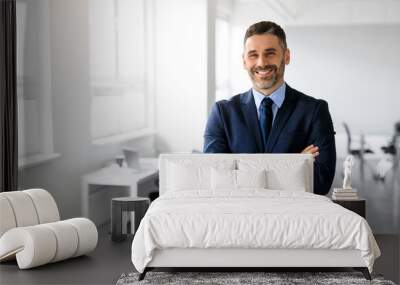 Happy middle aged man manager posing with arms crossed in office and smiling at camera, panorama, copy space Wall mural