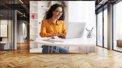 Happy Middle Eastern Businesswoman Using Laptop Sitting At Workplace Wall mural