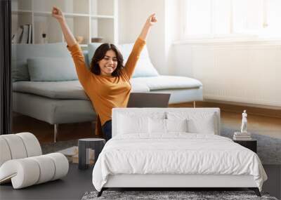 Happy Middle Eastern Female Student Celebrating Success With Laptop At Home Wall mural