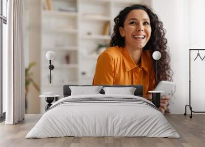 Happy Middle Eastern Lady Using Smartphone Sitting At Desk Indoor Wall mural