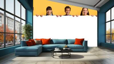 Happy smiling group of kids showing blank placard board Wall mural