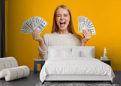 Happy teenage girl holding lots of money and shouting Wall mural