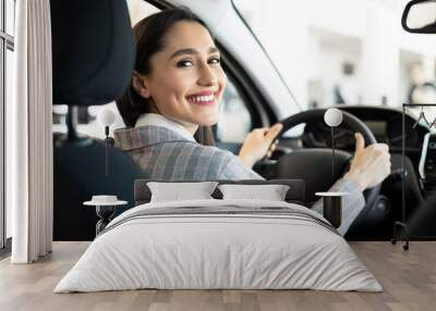 Happy Woman Sitting In Auto In Dealership Center Wall mural