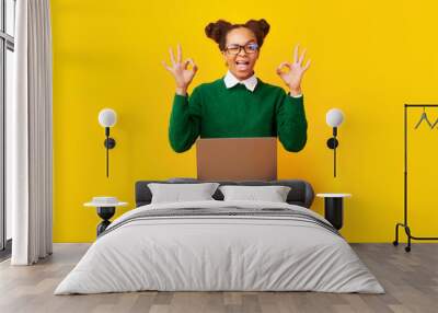 Happy young black woman showing ok gesture Wall mural