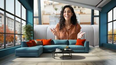 Headshot of happy young woman speaking to her friend on computer webcam, communicating remotely from home Wall mural