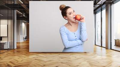 Healthy eating. Pretty girl biting fresh apple Wall mural