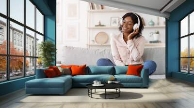 Home Leisure. Relaxed Black Girl In Wireless Headphones Listening Music Wall mural