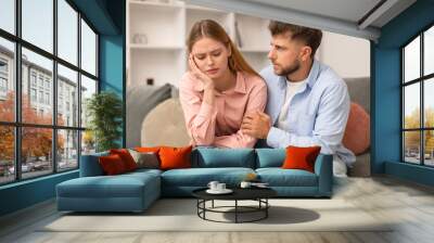 Husband Comforting Supporting Depressed Wife Sitting On Couch At Home Wall mural