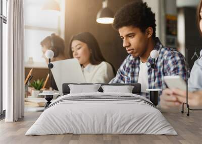 In the library, a diverse set of zoomers focuses on their screens, deeply engrossed in research. The mood is quiet yet energetic, fostering a spirit of shared learning. Wall mural