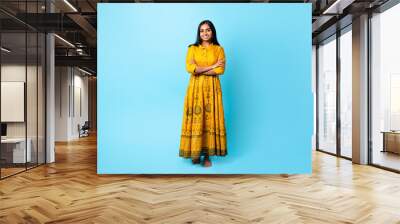 Indian Woman In Traditional Dress Crossing Hands Over Blue Background Wall mural