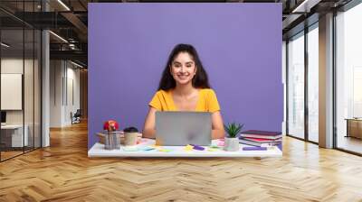 Indian woman using laptop sitting at the table Wall mural