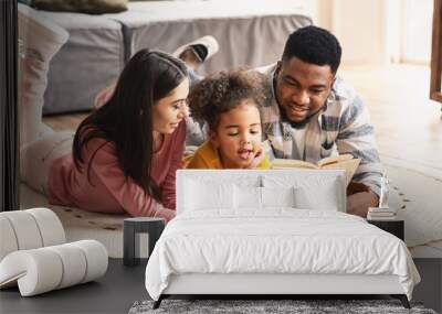 International family reading book on the floor Wall mural