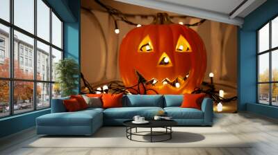 Jack o Lantern pumpkin with light garland on dark Wall mural