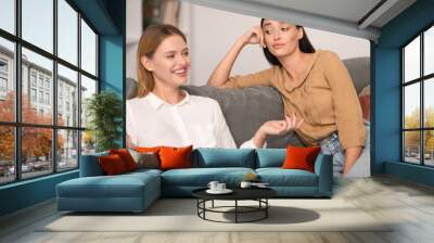 Jealous Lady Listening To Her Cheerful Friend Talking At Home Wall mural