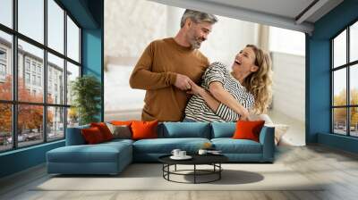 Joyful Couple Dancing And Laughing Having Fun At Home Wall mural