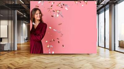 Joyful Girl Holding Balloons, Posing Over Pink Background With Flying Confetti Wall mural