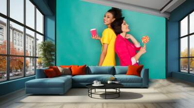 Joyful multiethnic women at azur studio background Wall mural