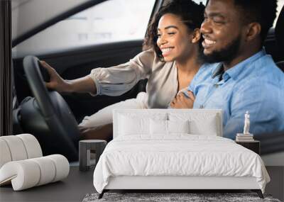 Joyful Spouses Testing New Car Sitting In Auto In Store Wall mural