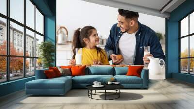 Little Arab Girl And Daddy Having A Bite In Kitchen At Home Wall mural