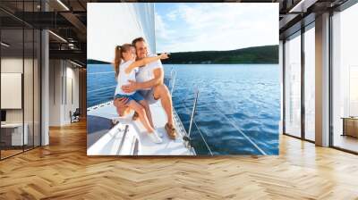 Little Daughter Showing Something To Father Sitting On Sailboat Deck Wall mural