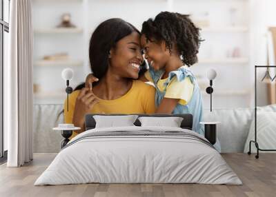 Loving African American Mother And Little Daughter Laughing And Bonding At Home Wall mural