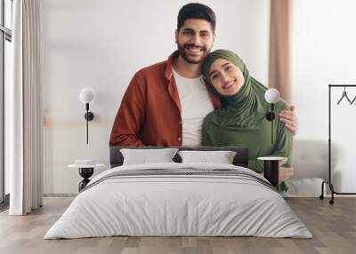 Loving Middle Eastern Couple Embracing Standing At Home Wall mural