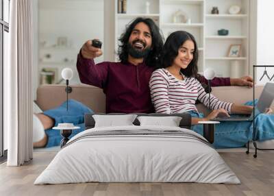 Loving young indian married couple relaxing at home Wall mural