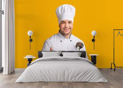 Male Chef Gesturing Thumbs Up Posing Holding Ladle Spoon Standing Over Yellow Background. Panorama, Studio Shot Wall mural