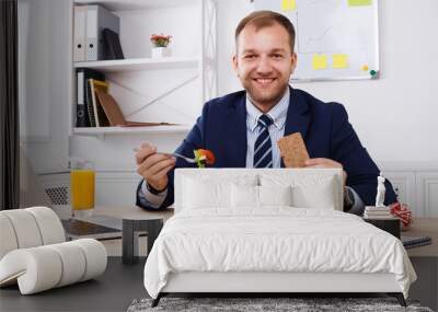 Man has healthy business lunch in modern office interior Wall mural