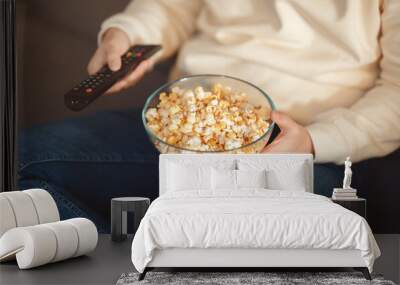 Man Holding Bowl of Popcorn and Remote Control, Cropped Wall mural