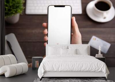 Man using blank smartphone on workplace desk Wall mural