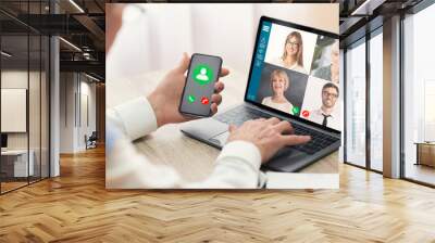 Mature businessman talking to colleagues in video conference Wall mural