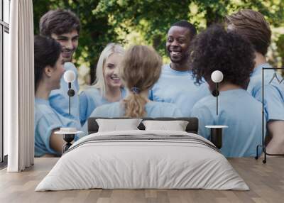 Meeting of young volunteers team in park Wall mural