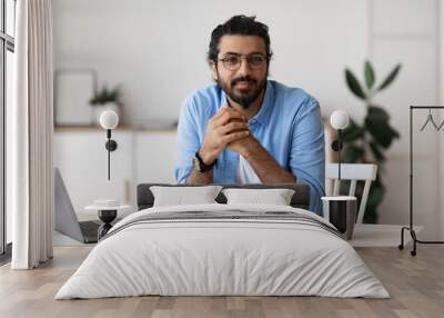 Millennial Freelancer. Portrait Of Young Arab Man At Desk In Home Office Wall mural