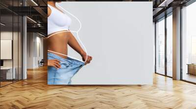 Millennial slim african american lady in big jeans, enjoy weight loss result with fat abstract body around Wall mural