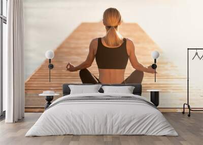 Morning Meditation. Rear view of sporty woman in activewear practicing yoga outdoors Wall mural