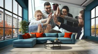 Motivated business team giving group high five Wall mural