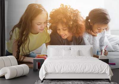 Multiethnic girls drawing at table with colorful pencils Wall mural