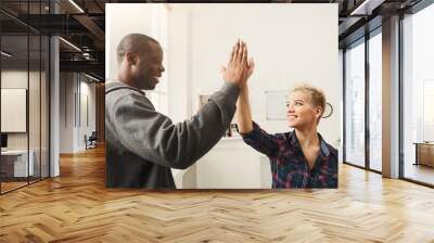 Multiethnic male and female hands putting hands together Wall mural