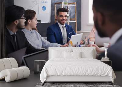 Multiracial business people discussing project at meeting Wall mural