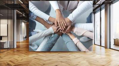 Multiracial business team putting hands on top of each other Wall mural